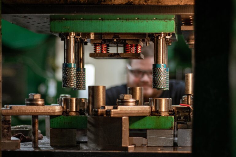 Press operator performing metal stamping