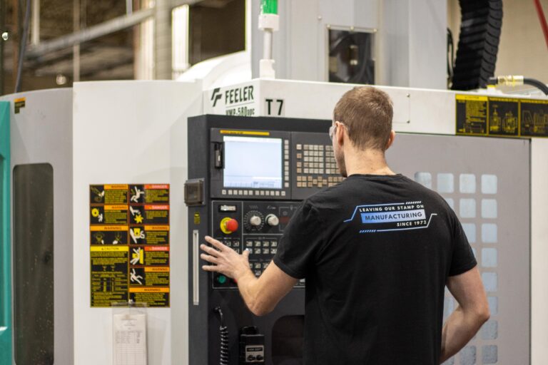 Operator running CNC precision machinery